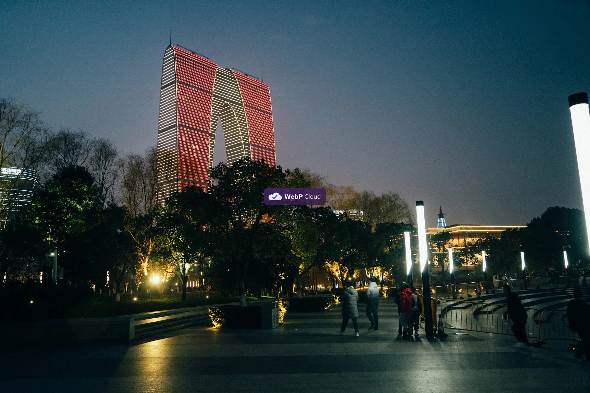 Gate of the Orient night photograph with the WebP Cloud mark composited over the centre